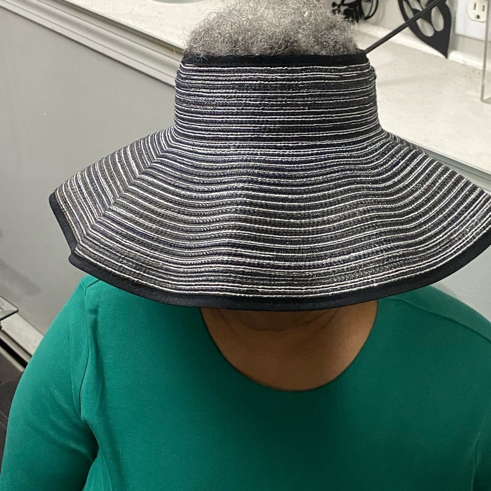 Like new visor hat. Black with silver. Bow accent.